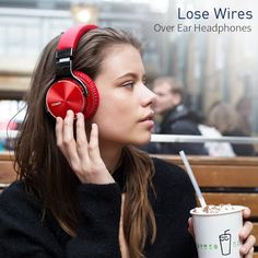 a woman wearing headphones and drinking coffee