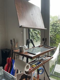 an easel is set up in front of a window to look out onto the yard