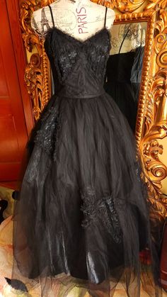 "This gorgeous formal gown is from the 50s by Emma Domb.  Rare solid black.  The underdress is made up of a black shiny acetate. There are two layers of tulle.  The under layer is a coarse tulle to give it its shape.  The outer layer is a finer tulle.  On the bodice and on the skirt are large lace bow appliques. The bodice is boned for structure. Side metal zipper.  There is one repair on the satin underdress near the hem where it looks like the original owners high heel might have gone through. You can't see this  when wearing the dress.  The hem of the tulle in some places has been trimmed (shown) This also does not show because of the fullness and the double layer of tulle.  This is a gorgeous gown and perfect for any formal event or Prom.  It was photographed with an extra petitcoat (n Black Tulle Ball Gown For Evening, Black Ball Gown With Fitted Bodice For Evening, Evening Ball Gown With Tulle Skirt, Black Tulle Ball Gown For Formal Events, Black Tulle Ball Gown For Formal Occasions, Formal Black Tulle Ball Gown, Black Organza Gown For Gala, Gothic Ball Gown For Evening, Black Organza Evening Gown