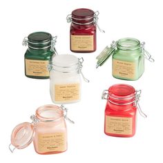 four jars with labels on them sitting next to each other