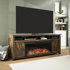 a living room with a fireplace and television on the wall in front of an entertainment center