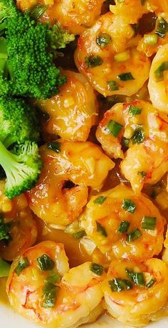 shrimp, broccoli and carrots are in a white bowl