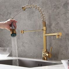 a person is washing their hands under a faucet in the sink with water running from it