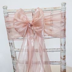 a chair with a pink bow on it