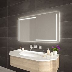 a bathroom with a sink, mirror and lights on the wall above it's counter