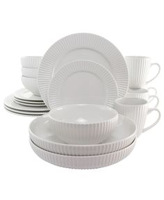 white dishes and cups are stacked on top of each other