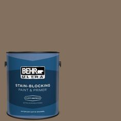 the behr ultra stain blocking paint and primer is shown in an open brown tin