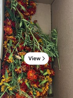 a box filled with lots of flowers next to a white sticker that says view