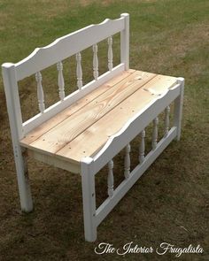 a white bench sitting on top of a grass covered field