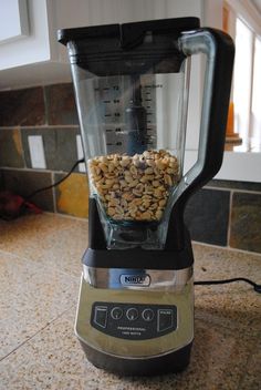 a blender filled with lots of food on top of a counter