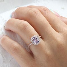 a woman's hand with a ring on top of it and a lace doily