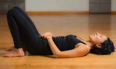 a woman laying on the floor with her legs crossed