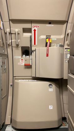 the inside of an airplane with two refrigerators