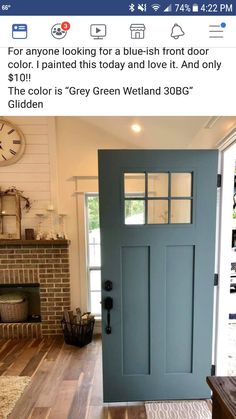 a blue front door in a house with hardwood floors