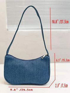 a blue purse with measurements for the bottom and side pockets, on top of a white table