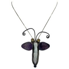 This is a stunning vintage Echo Of The Dreamer Pendant or Brooch in the form of a Butterfly or Moth with carved Amethyst Wings, a stunning Pearl body, Lapis Lazuli at the tail and in Sterling Silver. The wonderful insect can be worn as a pendant or as a brooch. It has dramatic design and is such a delight of color and form. And insect jewels are all the rage today. I love the elongated pearl set in the body with the carved amethyst wings and the blue lapis accent at the base. The pendant is 2 7/ Blue Lapis, Pearl Set, Lapis Lazuli, Moth, The Dreamers, Amethyst, Pendant Necklace, Sterling Silver, Pendant