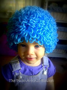 a young child wearing a blue wig and stethoscope