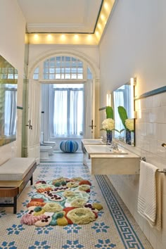 a large bathroom with blue and white tiles on the floor