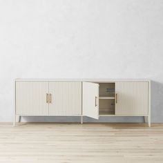 an empty room with a white cabinet and wooden floors