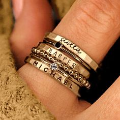 Personalized stackable ring set, engraved with names, dates, or special words. All 6 rings shown in the photos are included in this listing.  Choose between mixed metals, fine silver, or 14K yellow gold-filled for your set! MIXED METALS include: 2 - yellow gold-filled name rings 1 - fine silver name ring 2- sterling silver birthstone rings 1 - yellow gold-filled beaded ring This ring set includes three name rings, a beaded ring, and two cz rings Metal: 14k gold filled, .999 fine silver, .925 ste Gold Name Ring, Stackable Name Rings, Cz Rings, Stacked Rings, Rings Stacking, Ring Spacer, Rings Metal, Multiple Rings, Name Ring