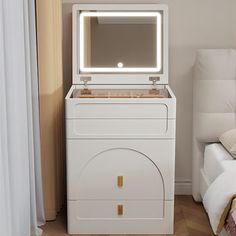 a white washer sitting next to a bed with a mirror on top of it