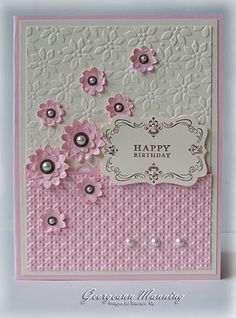 a pink and white card with flowers on it