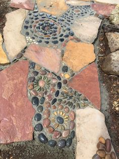 a close up of a stone walkway with rocks and stones