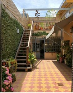 an outdoor area with stairs and potted plants