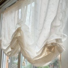 the curtains are pulled back and hanging on the window sill in front of the windowsill