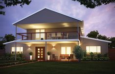 an image of a two story house at night with lights on the porch and balcony