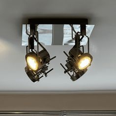 two lights that are hanging from the ceiling