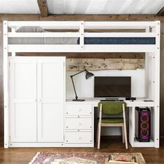 a white loft bed with desk and computer on it in a room that has wood flooring