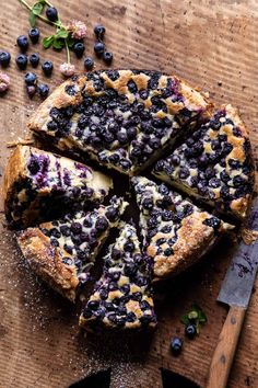 a blueberry cheesecake cut into slices on a cutting board