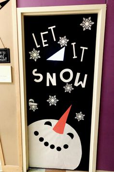 a door decorated to look like a snowman with the words let it snow on it