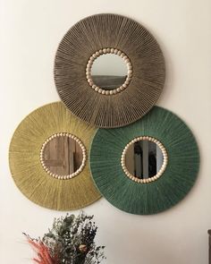 three circular mirrors hanging on the wall