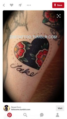 a heart tattoo with flowers and the word love on it