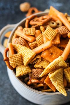 a bowl filled with cheetos and pretzels