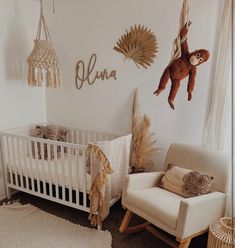 a baby's room with a crib, rocking chair and teddy bear