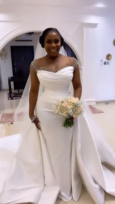 a woman in a white wedding dress posing for a photo