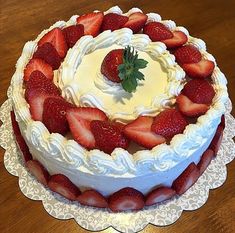 there is a cake with strawberries on the top and frosting in the middle