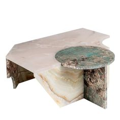 a marble coffee table with an abstract design on the top and bottom, sitting against a white background