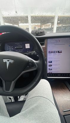 the interior of a car with a laptop on the dashboard and an electronic device in front of it