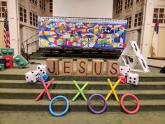 the word jesus spelled out in letters with dices and xo on top of them