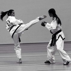 two women in black and white are practicing karate