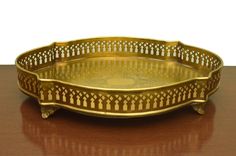 a golden tray sitting on top of a wooden table