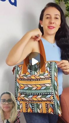 a woman is holding up a colorful handbag