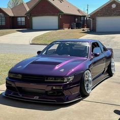 a purple car parked in front of a house