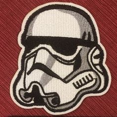 the star wars logo is shown in black and white on a red shirt with an image of stormtrooper's helmet