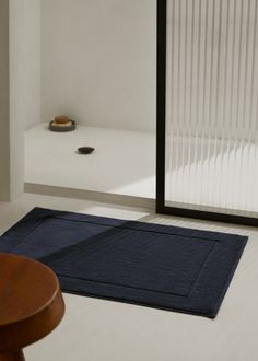 a blue rug on the floor next to a wooden table