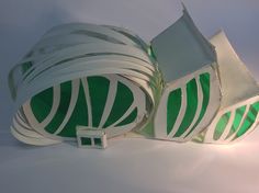 there is a green and white object that looks like it's made out of paper